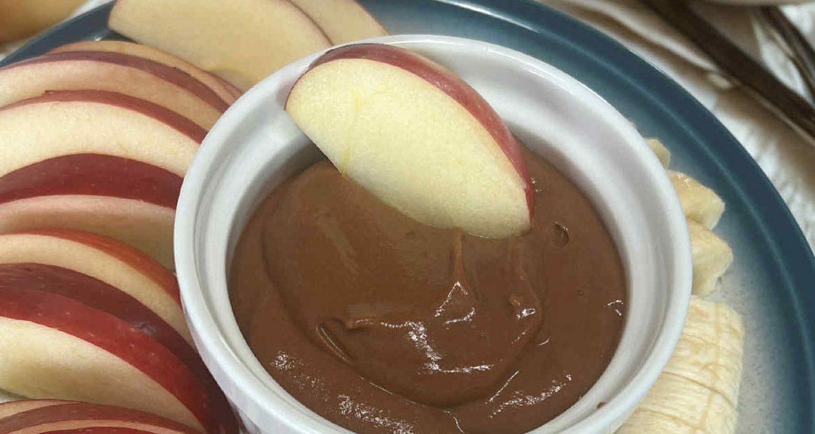 Homemade healthy chocolate pudding in a cup, ready to dip your apples and bananas in