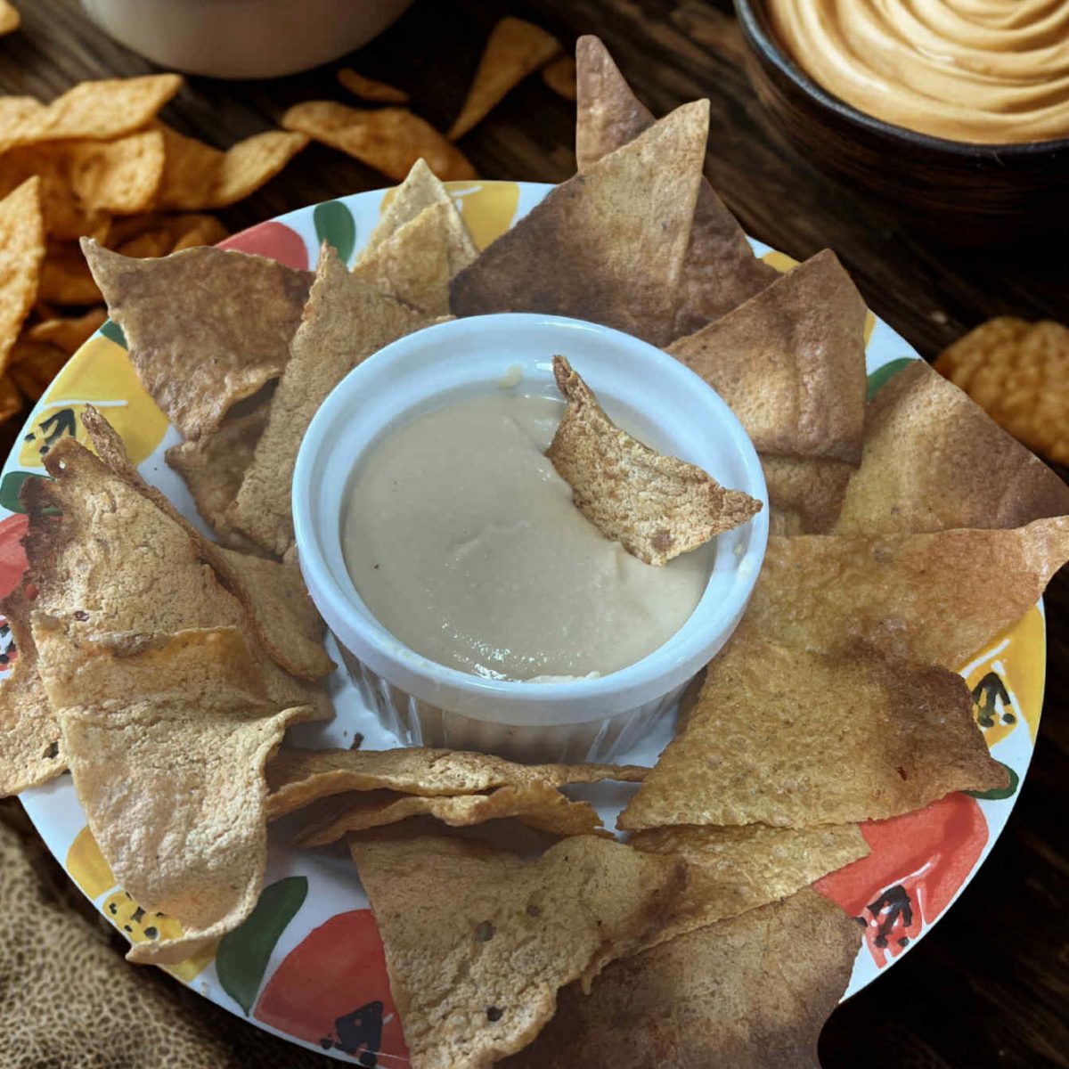 Oil-free homemade hummus in a cup ready to serve with chips