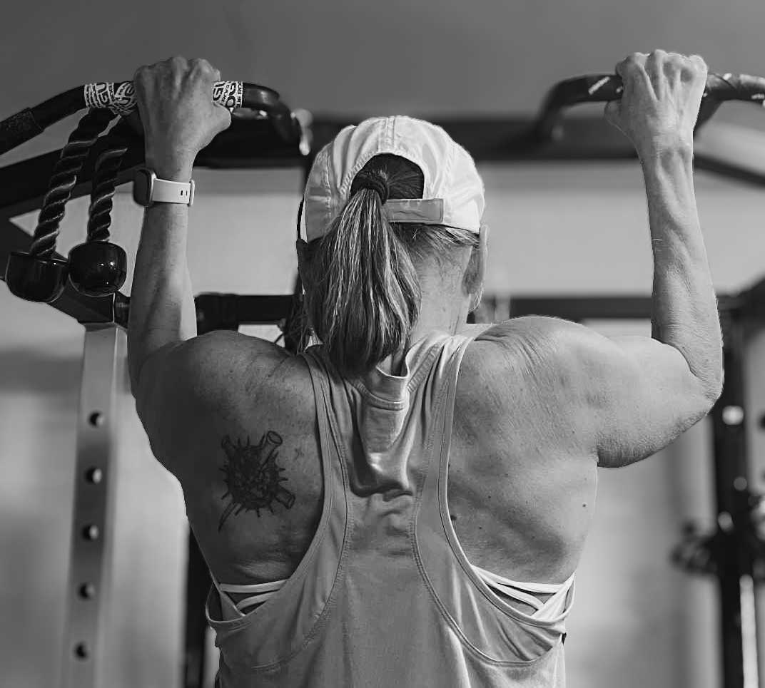 Susan doing a pull up on the rack at Haven Garage Athletics gym