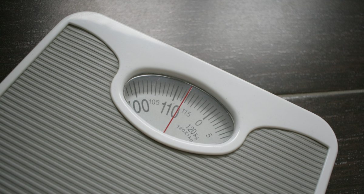 a bathroom scale sitting on top of a wooden table