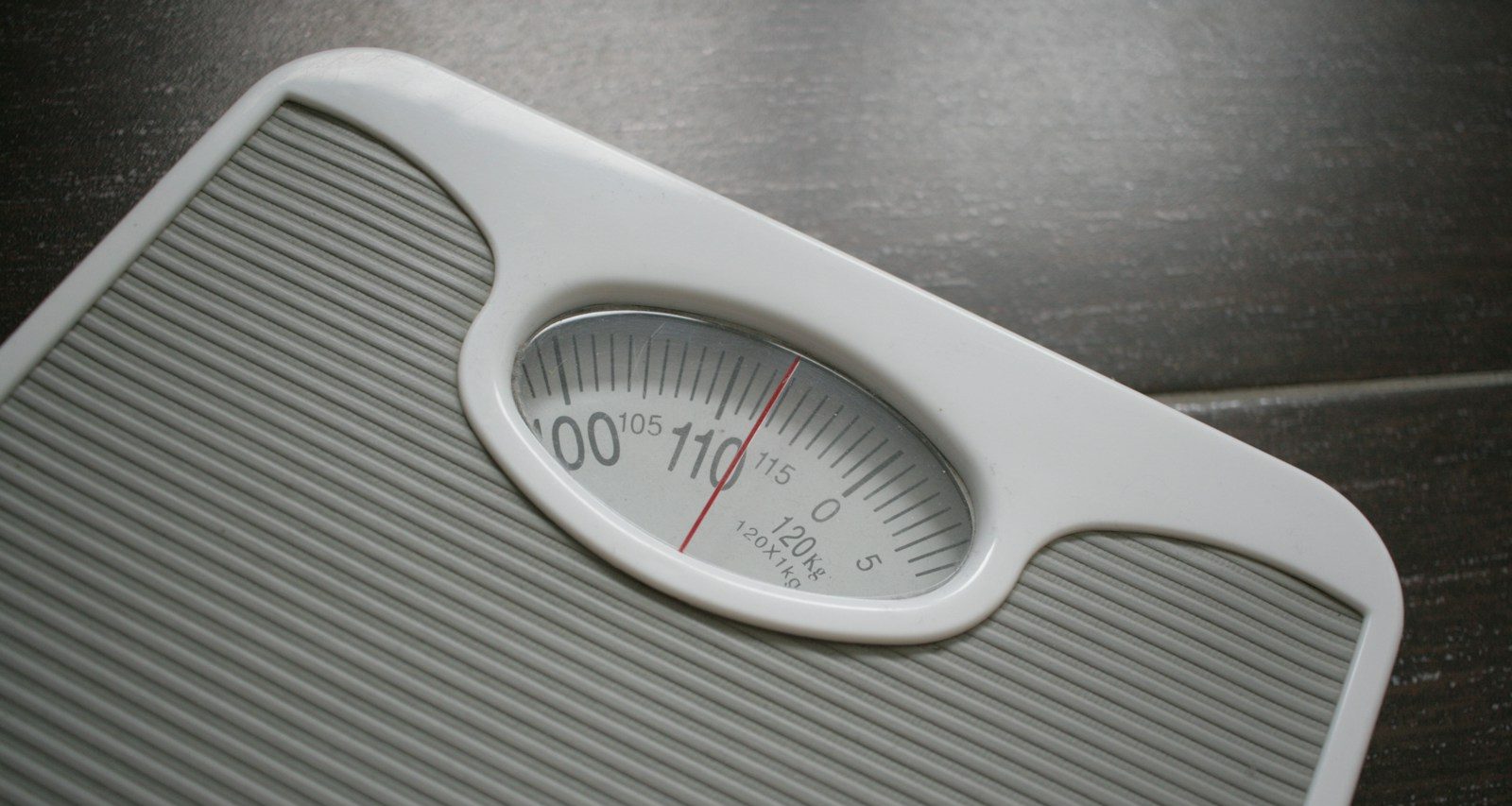 a bathroom scale sitting on top of a wooden table